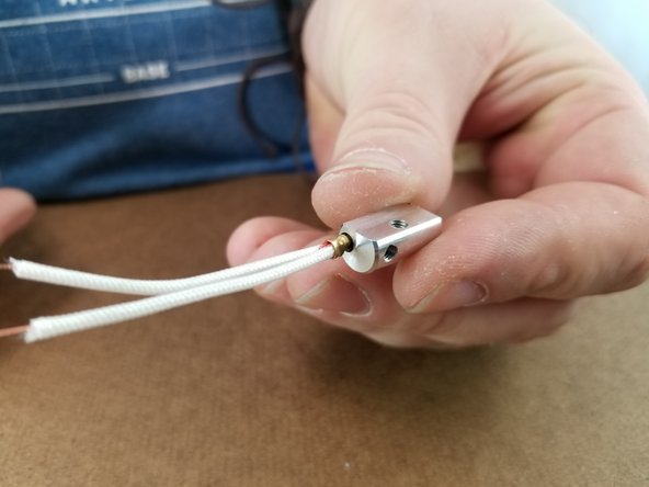 Use one of the M3 x 10mm long screws to secure the thermistor in place.