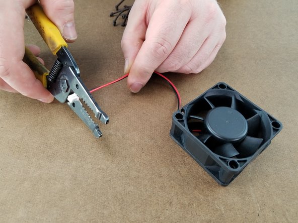 Cut off the white plug from the fan as close to the plug as possible and discard this plug as shown in Pic 2.