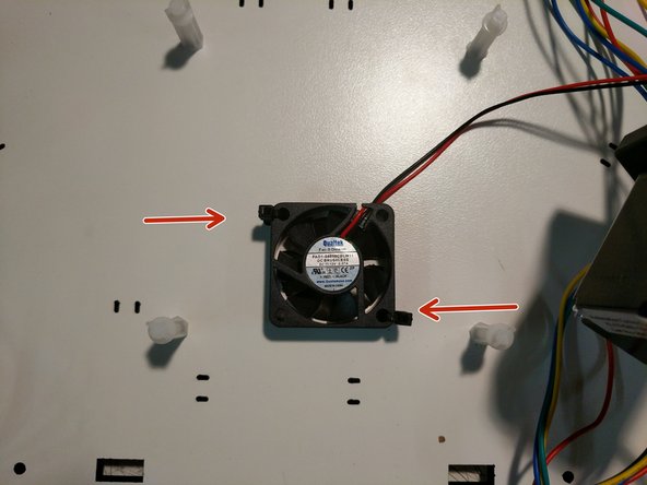 Attach the fan that you prepared in the previous step to the top base plate using (2) zip ties as shown. Note the correct orientation of the fan. The label will be facing up.