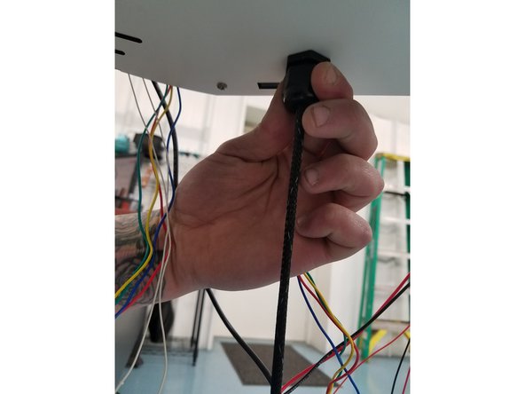 After cutting the zip ties, you will need to uninstall the whip. To do this Grab the black plastic Cable Mount Hub on the bottom side of the Laser Cut Plate and turn it counter clockwise until you feel the start to fall through.