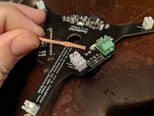 I set my soldering iron to 476c (about 880 F) on my soldering iron for this task.  Heat your soldering iron and get your desoldering braid ready as shown in pic 1.