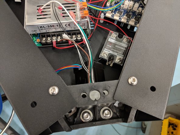 You will now install the Z tower, similarly to how you installed the X tower. The Z tower is the one in which you previously ran wires down. Start by making sure the end-stop legs are folded over.