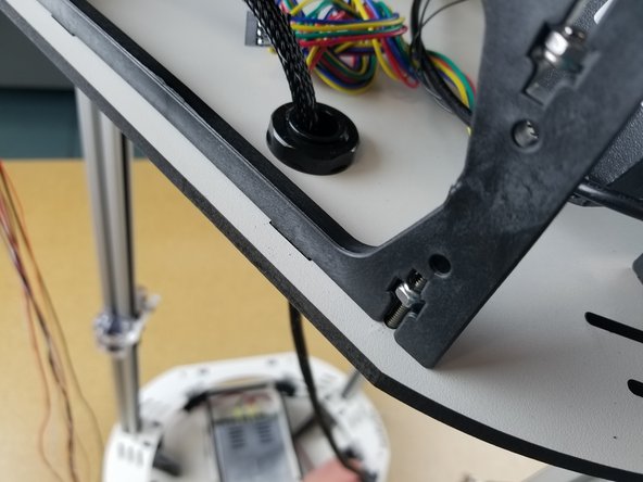 Pull the end of the whip all the way to the bed of the printer and touch the bed clamp closest to the Y tower.