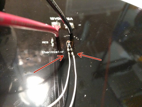 Fan out the exposed strands of wire for the 12awg red and black wires. Solder them to the heated bed in the location indicated. NOTE: These are large wires and pads. You will need to ensure that the pads and wire strands get hot enough to wick the solder throughout resulting a good solder joint. Apply additional solder as needed.