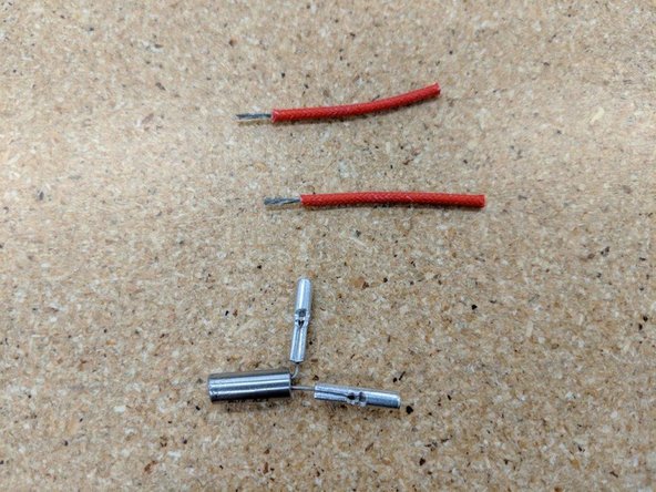 Locate the two red insulated wires in the kit and strip off the ends as shown in the first picture approximately as long as half the crimp.  7 mm works fine.
