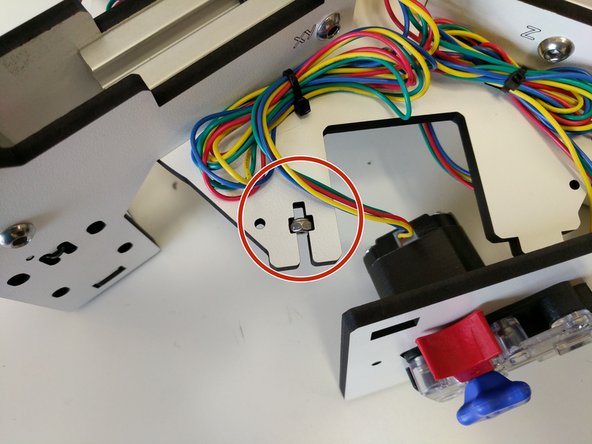 Insert (2) nylon lock nuts into the &quot;t&quot; shaped cuts in base assembly top and bottom plates. The flats of the &quot;t&quot; shaped cuts will be against the flats on the nuts.  Match the orientation for the nut (for the nylon insert) with that in the image.