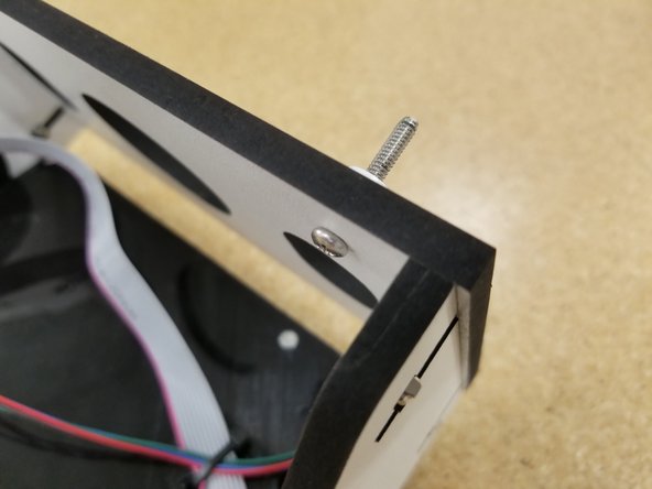 The mount will install in the pre-cut holes shown by the arrows.