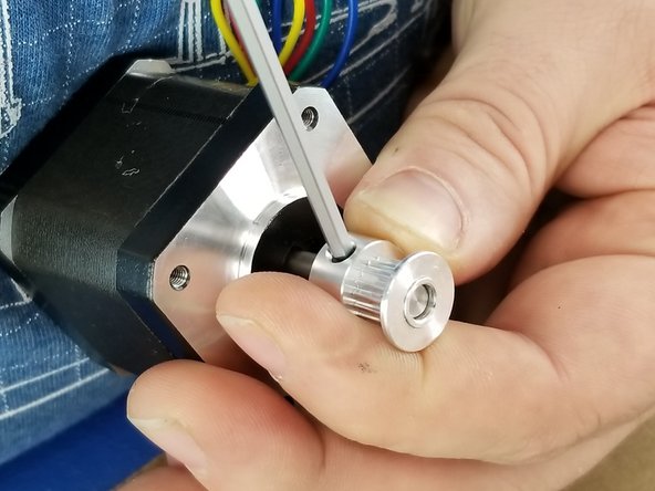 You will notice the shaft of the motor does not fully come to the end of the pully.  This is normal. The bottom of the pulley should be sitting approximately 8-9mm from the black flat of the motor.