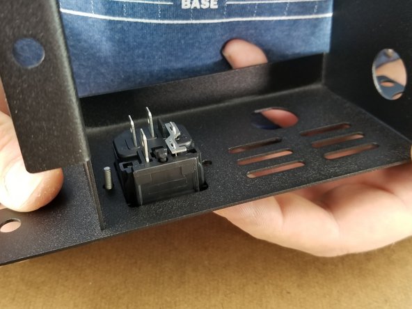 Using the M3 x 10mm long screws from the outside of the bracket, insert the screw through the plug reciever and power supply bracket.