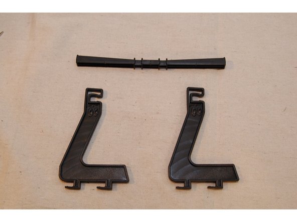 Rotate the spool support bar so that the angled face of the bar is facing away from you.