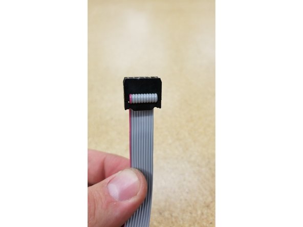 Hold the loose end of the ribbon cable and fold it exactly as shown in photos 1, 2, and 3.