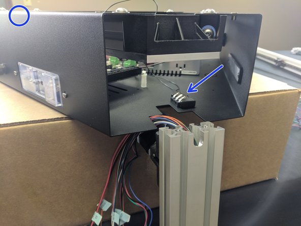 The X Tower will be the first tower to be installed. This tower is the one with the extruder and whip pre-installed. To begin, you will want to elevate the printer's upper assembly so it is up higher than the length of the rail. For our assembly we used the box that the upper assembly came in.