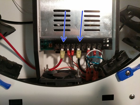 Route them under the large arc of the PSU blocker and attach them to the power supply. The locations are indicated by arrows in the image.