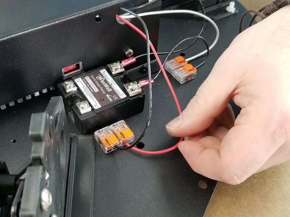 Secure the ring terminal to the power supply to the first location under the label for +V.  You will have 2 empty screw terminals on the power supply between this red wire and the black wire installed in the previous step as shown in Pic 2.