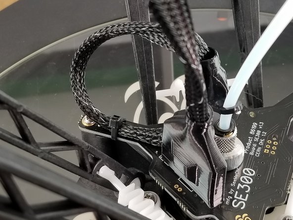 Take a zip tie and secure the loop to the hotend board as shown in the pictures.