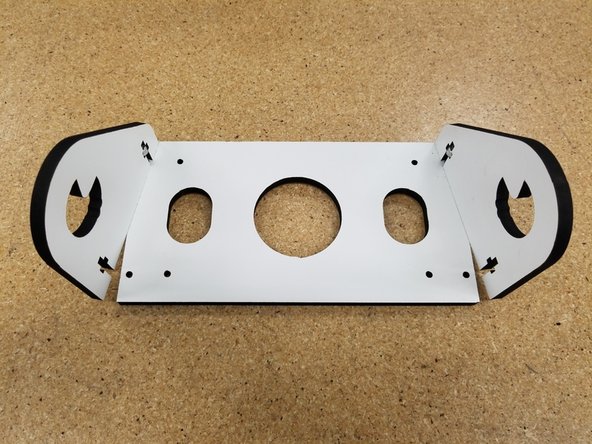 Insert the 6-32 nylon lock nuts in the laser cut side panels and insert the 6-32 1" machine screws in the shorter end of the panel as seen in the photo. Don't tighten these all the way, keep them somewhat loose for what's to come.