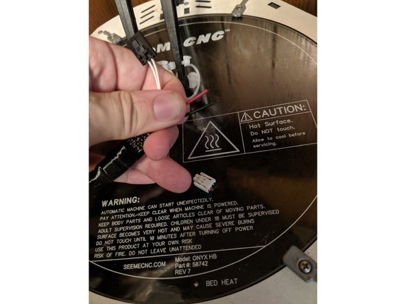Locate the white 2 pin power plug and cut off the plug to remove it.  Cut the wires as close to the white plug as possible to give you the most wire to work with as shown in Pic 2.