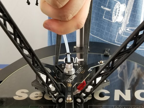 Insert the loop of the other lanyard on the PTFE tube of the lower part of the PTFE.  Insert the PTFE tube into the top of the hotend and fully seat it.