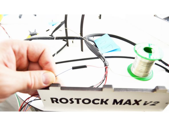 Slide the heat-shrink up over the connection that you soldered and heat it with a lighter.