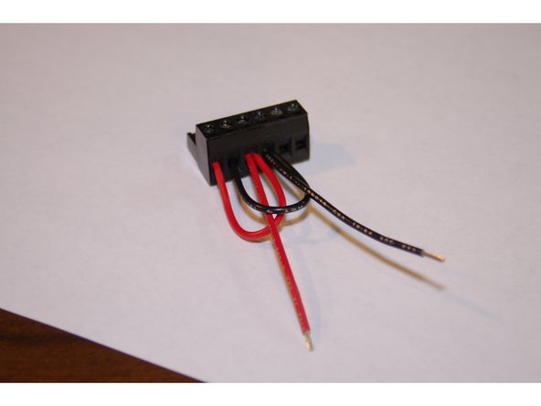 Remove the insulation from the pre-stripped 50mm, 18ga red &amp; black wires and insert them into the compression terminal at the locations shown. Fully tighten each connection!