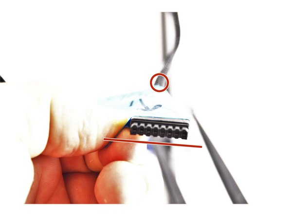 You want to insert the bowden tube into the mesh loom on the same side of the connector that has the beveled edges. This is noted in the picture with red makers.