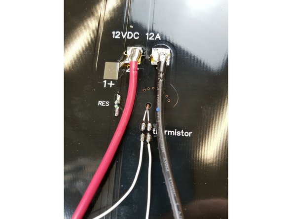 Solder the thermistor leads to the pads where indicated. There is not polarity so either wire on either pad will work. Since these pads are smaller, you want to be sure not to heat them too hot for too long or the pad can detach from the board.