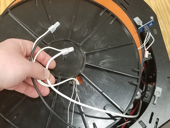 Pass the silicone heater wires through the existing plastic bed insulator as shown.