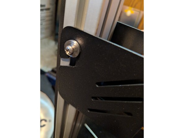 Place the extruder on  the hanger you installed in the previous step as shown in Figure 1.