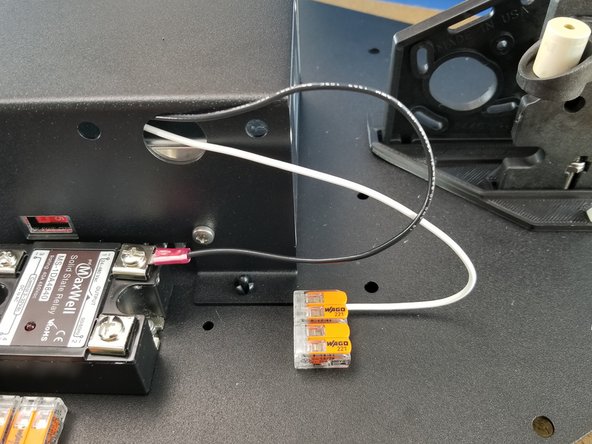 To attach the wire to the connector, lift the orange cover on the connector, insert the wire, and close the orange cover to secure the wire in place.