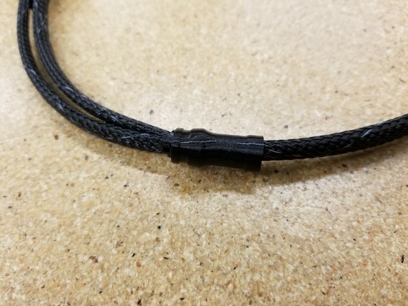 Rout the cables and mesh loom through the loom splitter, using it to cover the joint between the three sections of mesh loom.