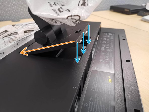 Tilt and slide the Monitor Arm into the bracket