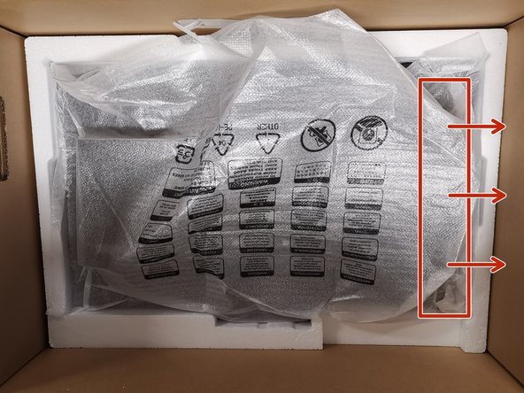 Carefully, grab one side of the monitor.