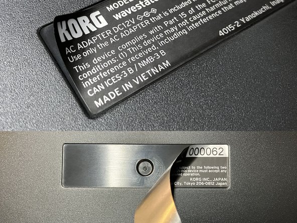 Flip over the plastic enclosure and locate the serial number label on the bottom.