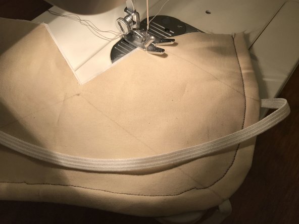 Sew along all four of the straight lines that you just drew, extending all the way to the edges of the mask. Be careful to avoid the elastic straps.