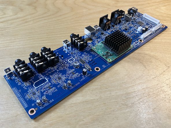 Slide the main board slightly away from the rear panel, then lift it up and out of the plastic enclosure entirely.