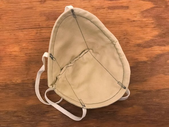 Open the mask and turn it inside-out. The stiffness of the interface material might make this process sort of crinkly.