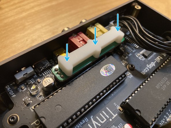 Place the white plastic spacer on top of the installed jumper board so that its 3 pegs are facing down and are lined up with the 3 holes in the jumper board.