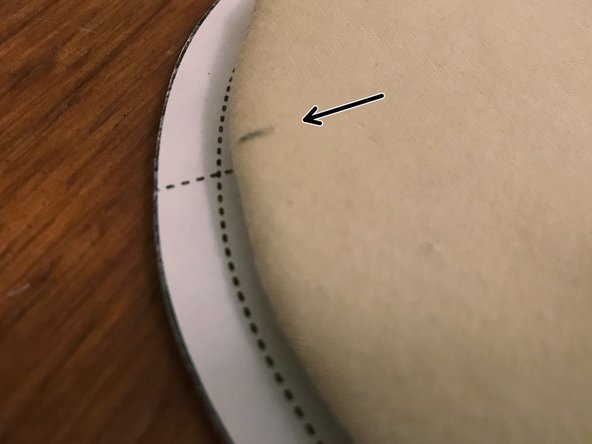 Make two small marks along the edge of the mask where the dashed lines on the pattern intersect it, as shown.