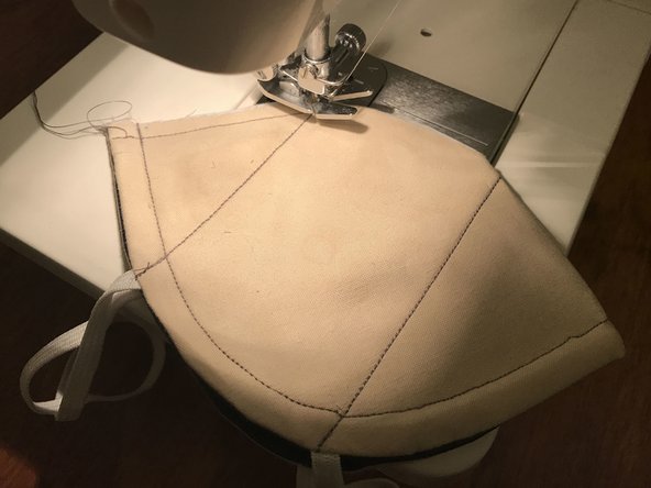 The mask should be inside-out, so that the inside of the mask (lighter fabric, if applicable) is facing out.