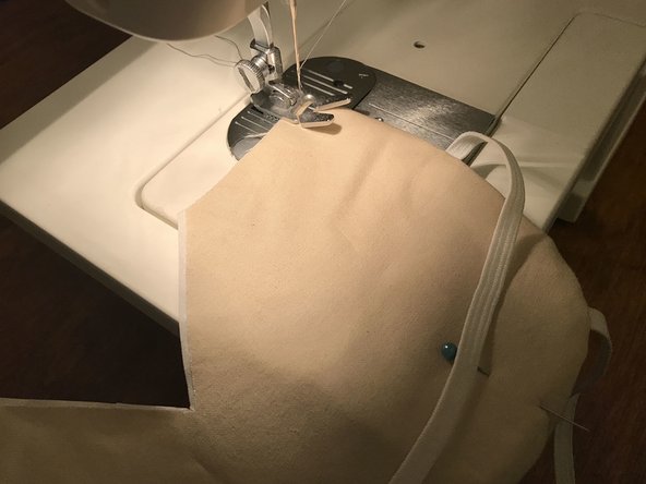 Starting from one corner, sew around the curved part of the mask, leaving a 1/4&quot; (6 mm) gap from the edge, just like you did before.
