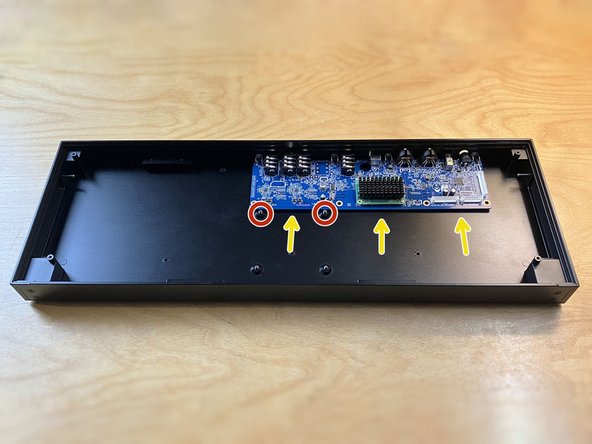 Position the main board in the enclosure so the jacks are lined up with the holes in the rear panel.