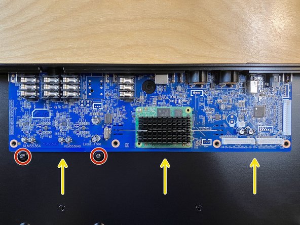 Be careful not to scrape the underside of the main board on the ends of either of the two nearby VESA mounting screws.