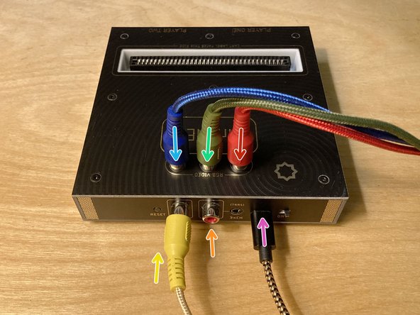 The new red RCA cable goes in the red RCA jack on the top of the console. Note that the audio RCA jack on the back of the console is also red. Try not to get the two red RCA cables mixed up.