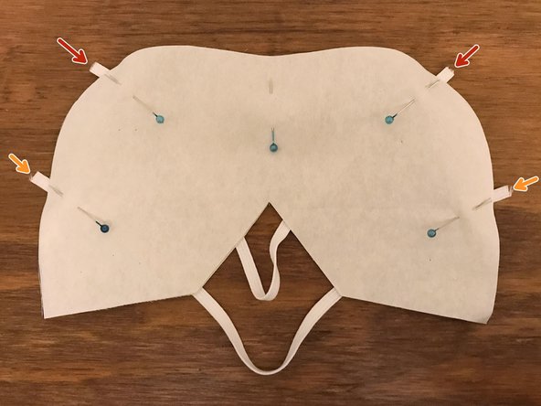 Position the strap so that it runs between one of the upper points that you just marked and the top of the V-shaped cutout.