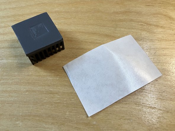 Locate the piece of white silicone-coated release paper included in the parts bag. Make sure the shiny side of the release paper is facing up.