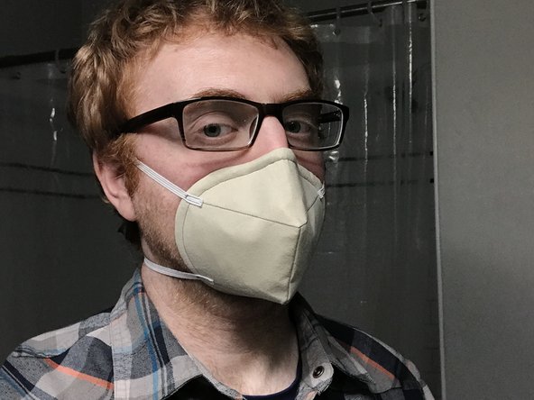 When wearing a mask like this, it should fit snugly around your nose and mouth.