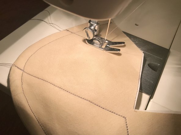 The two upper lines can be sewn in one continuous operation. When you get to the center point, make sure that the needle is down, lift up the presser foot, rotate the mask around the needle, then put the foot back down before continuing to sew.