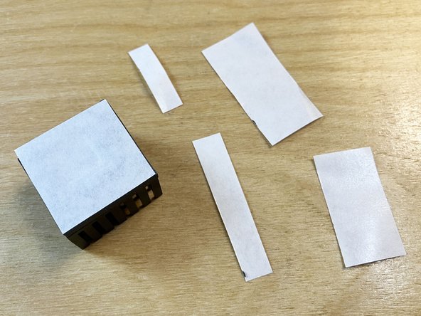 Using a pair of scissors, trim the edges of the release paper so they're flush with the thermal pad. Discard the trimmed paper scraps.