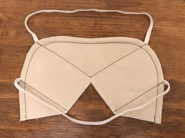 The two upper lines can be sewn in one continuous operation. When you get to the center point, make sure that the needle is down, lift up the presser foot, rotate the mask around the needle, then put the foot back down before continuing to sew.