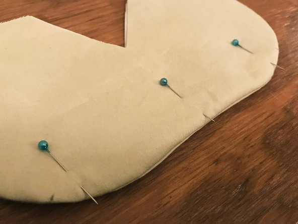 Place the prepared nose bridge insert inside the mask, between the two layers of interface material.